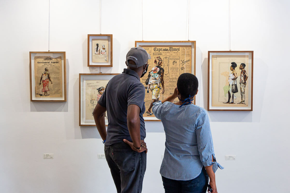 Gallery visitors looking at artworks by Lisette Forsyth